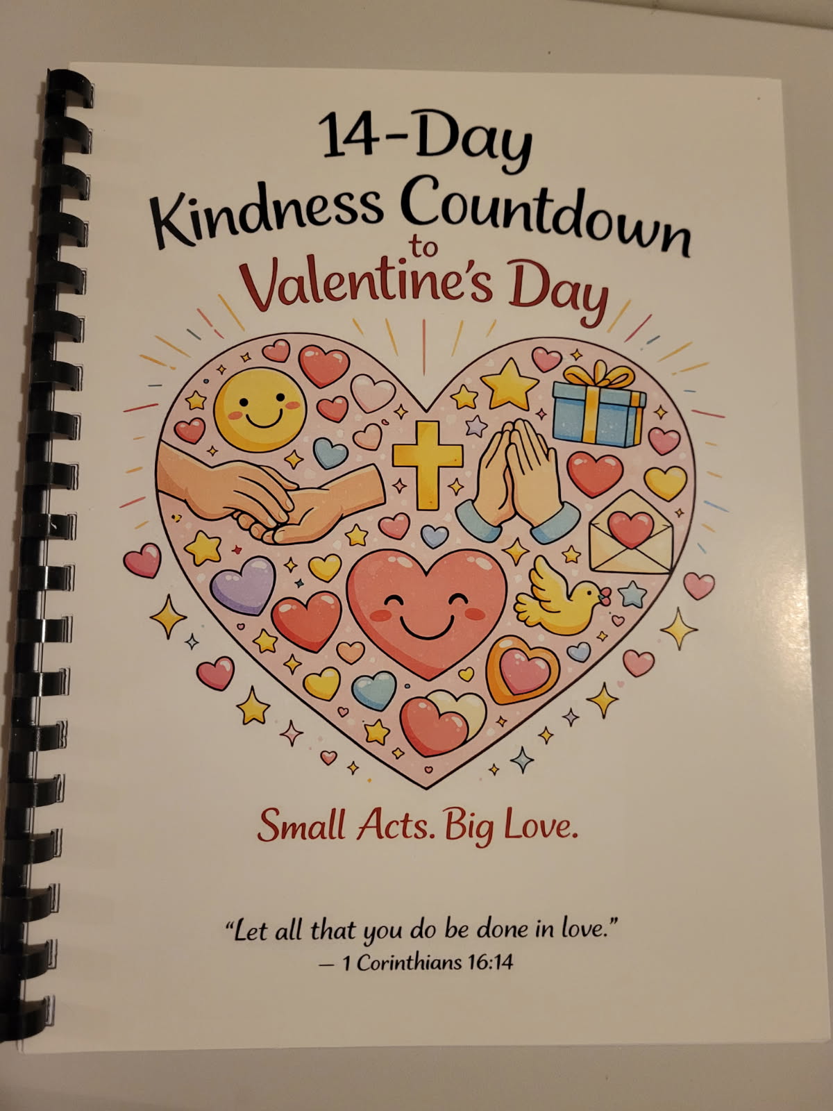 Cover of a children’s booklet titled “14-Day Kindness Countdown to Valentine’s Day” with a heart-shaped illustration showing symbols of love, faith, and kindness.