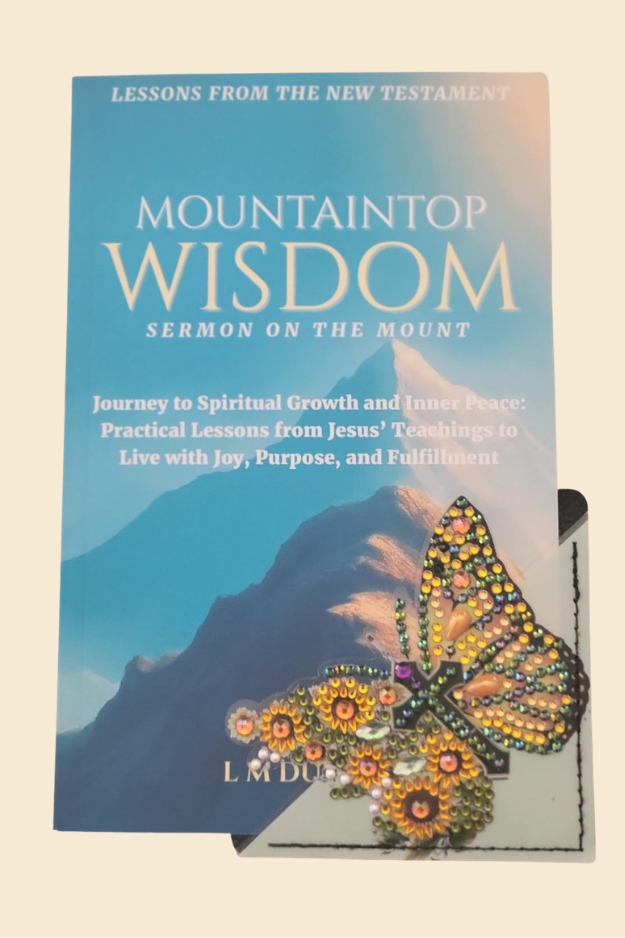 Colorful butterfly corner bookmark placed at bottom corner of Mountaintop Wisdom book