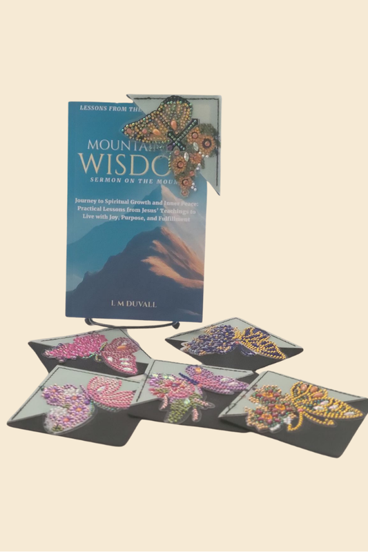 Colorful butterfly corner bookmarks placed on book pages with Mountaintop Wisdom book in background
