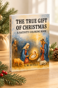 3D paperback mockup of The True Gift of Christmas: A Nativity Coloring Book by L. M. Duvall, featuring Mary, Joseph, baby Jesus, and the Nativity scene, displayed on a light wooden tabletop with festive evergreen greenery and warm Christmas accents.