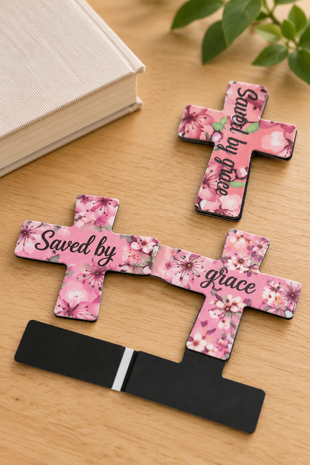 Pink floral “Saved by Grace” cross magnetic bookmarks shown open and closed to demonstrate the magnetic folding design.