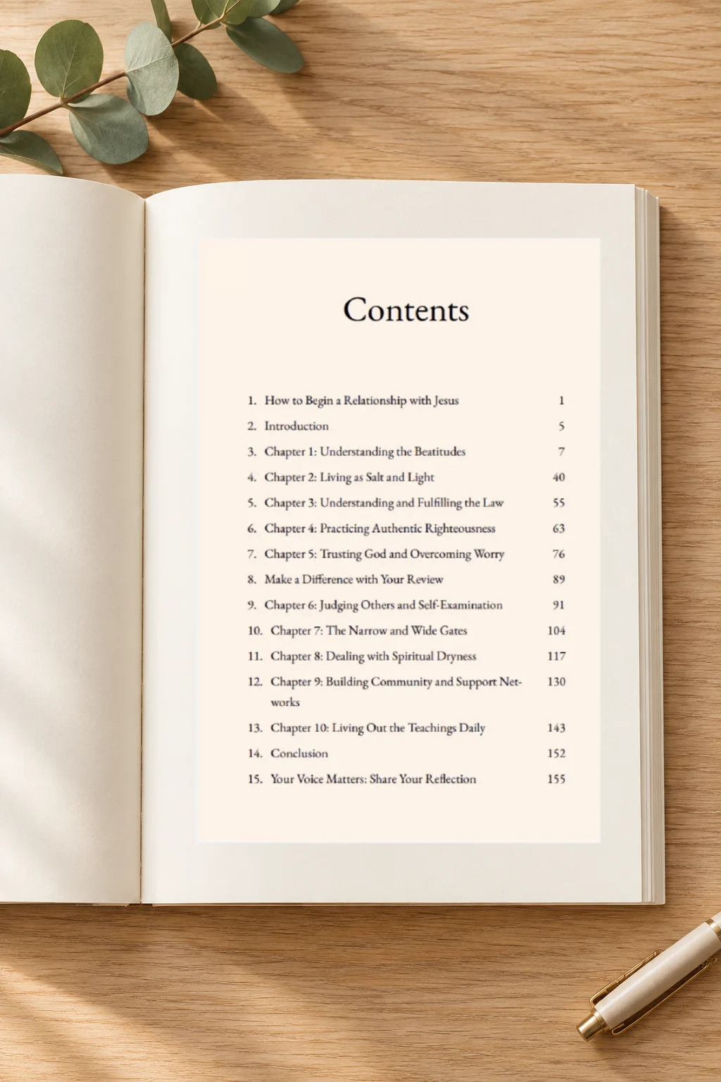 Open Mountaintop Wisdom Bible study showing the table of contents on a light-oak table with greenery and a pen.